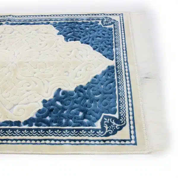 white & blue Muslim prayer mat