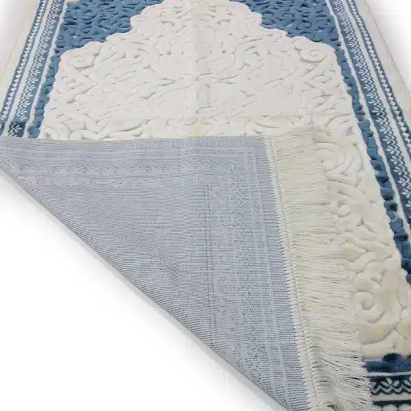 white & blue Muslim prayer rug